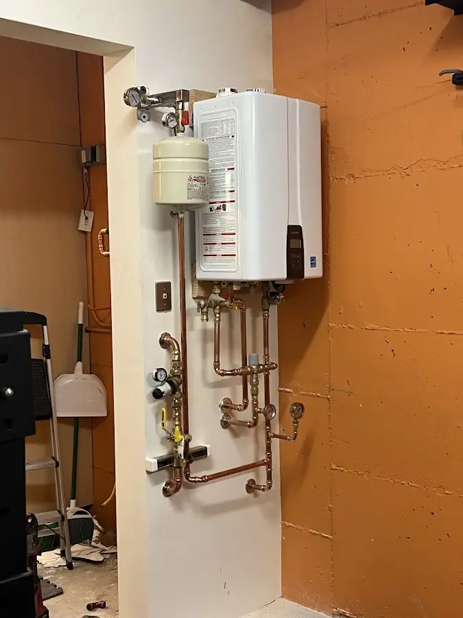 Plumbing technician inspecting water heater connections in Galway